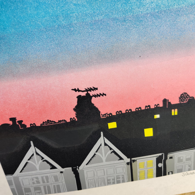 Close-up detail of Over the Road lino print of a row of terraced houses against a blue and pink sky background